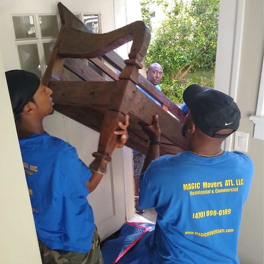 Magic Movers ATL crew carefully carrying furniture during a residential move